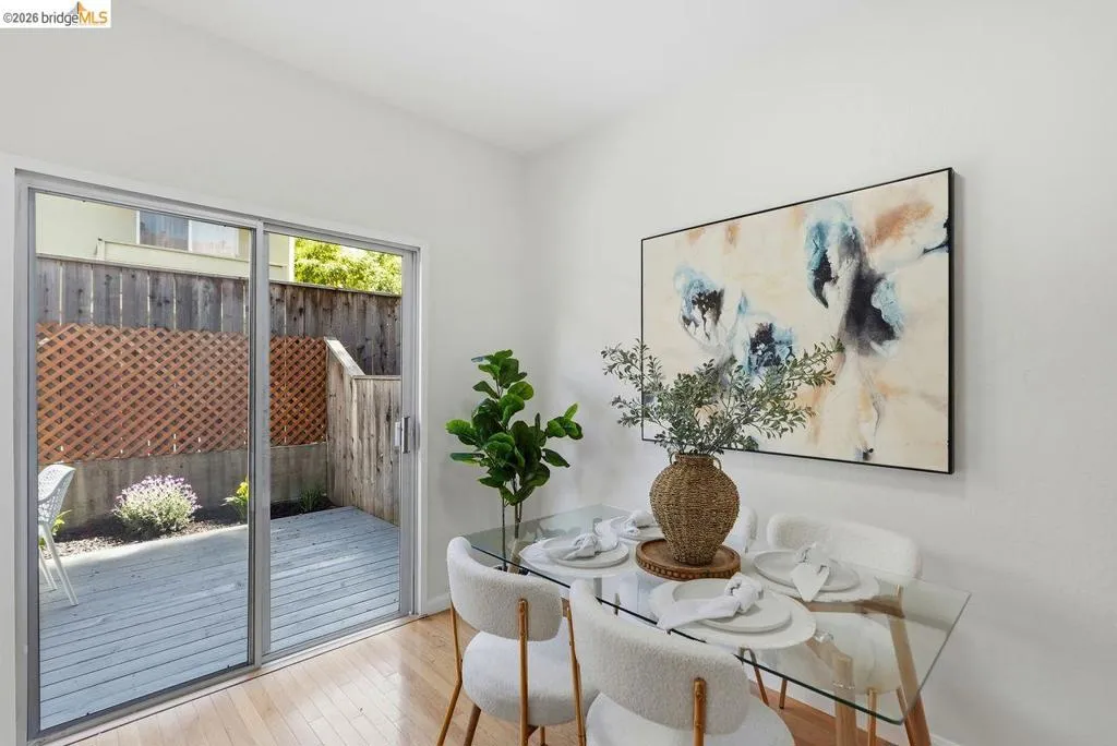 Patio access from an interior room featuring wood-finish flooring
