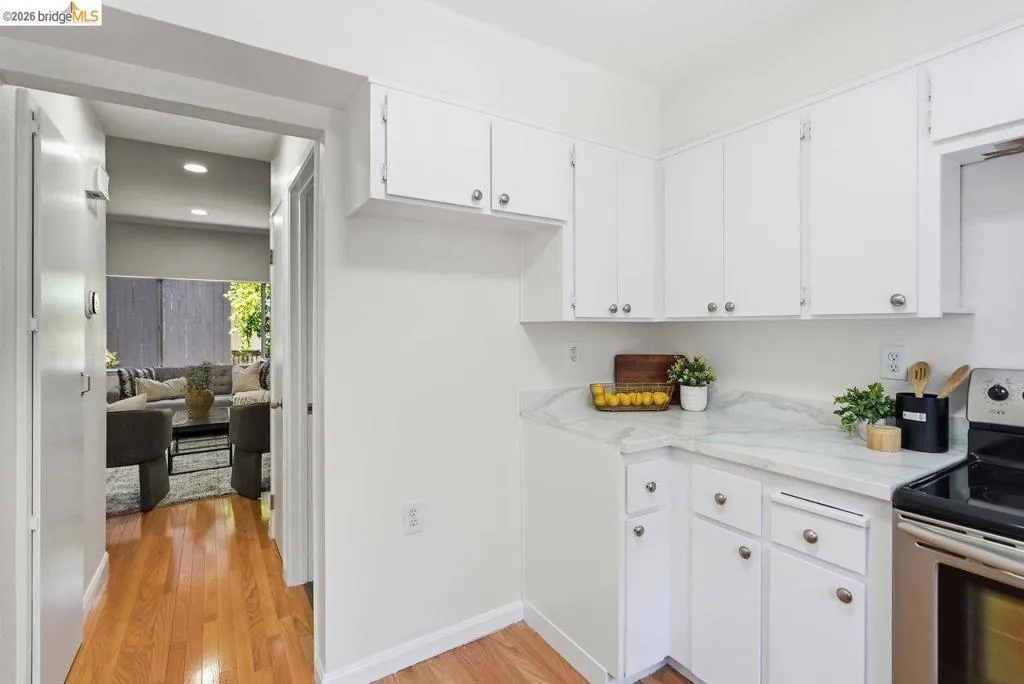 Kitchen featuring white cabinetry and light-toned countertops