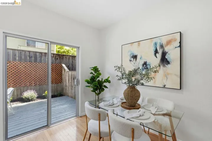 Patio access from an interior room featuring wood-finish flooring
