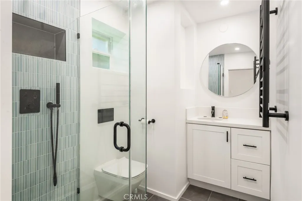 Lower unit - Luxurious downstairs bath with frameless shower, custom tile, towel warmers and more