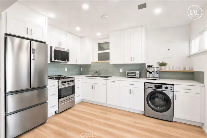 Lower unit - Open concept layout in the beautifully remodeled downstairs unit - digitally enhanced to remove tenant furniture and belongings