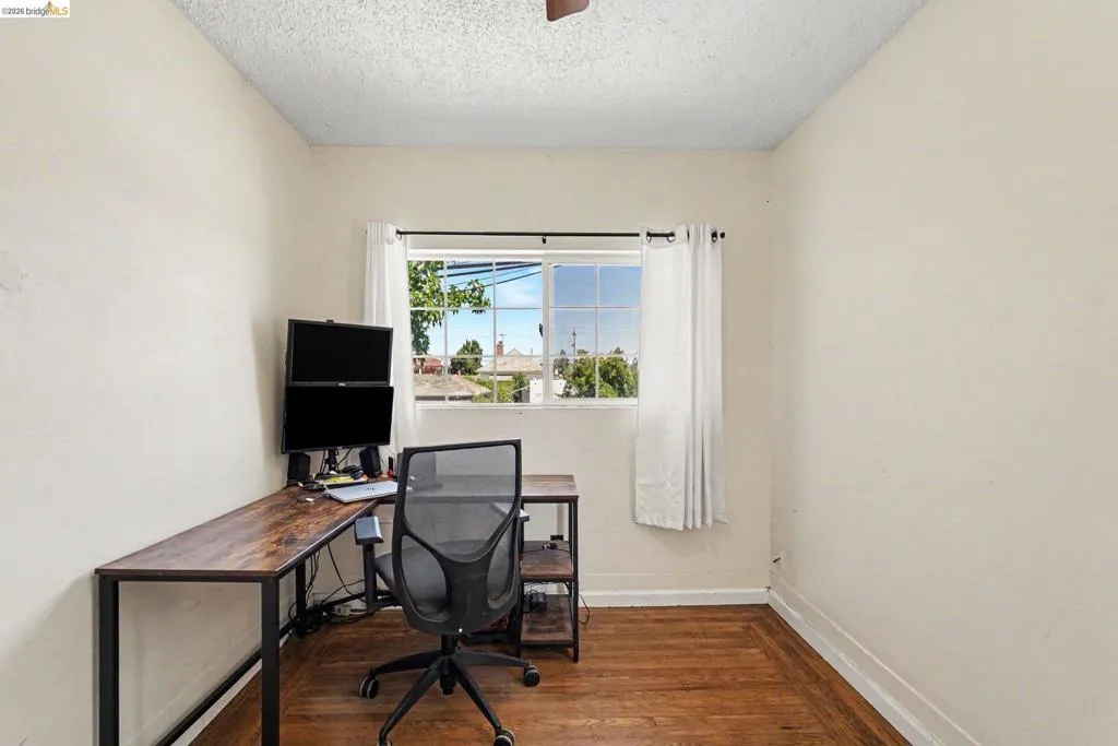 Room with wood-finish flooring and neutral wall tones