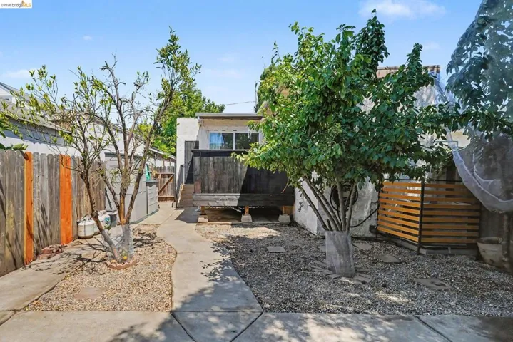 Rear exterior with elevated wooden deck and sliding glass door