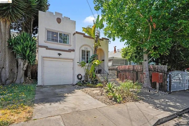 Stucco exterior with a single-car garage and an arched entryway