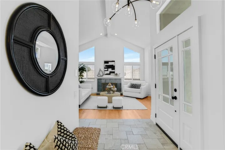 Entryway between living and family rooms with new front door and sidelight.
