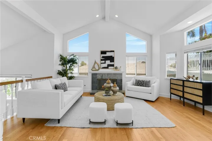 Living Room with gas fireplace, high open beam ceilings, natural light pouring in all the windows.  City View!  refinished hardwood flooring.