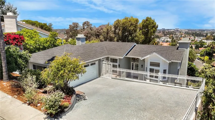 Hillside view home with multiple vehicle driveway parking and oversized 2 car garage.