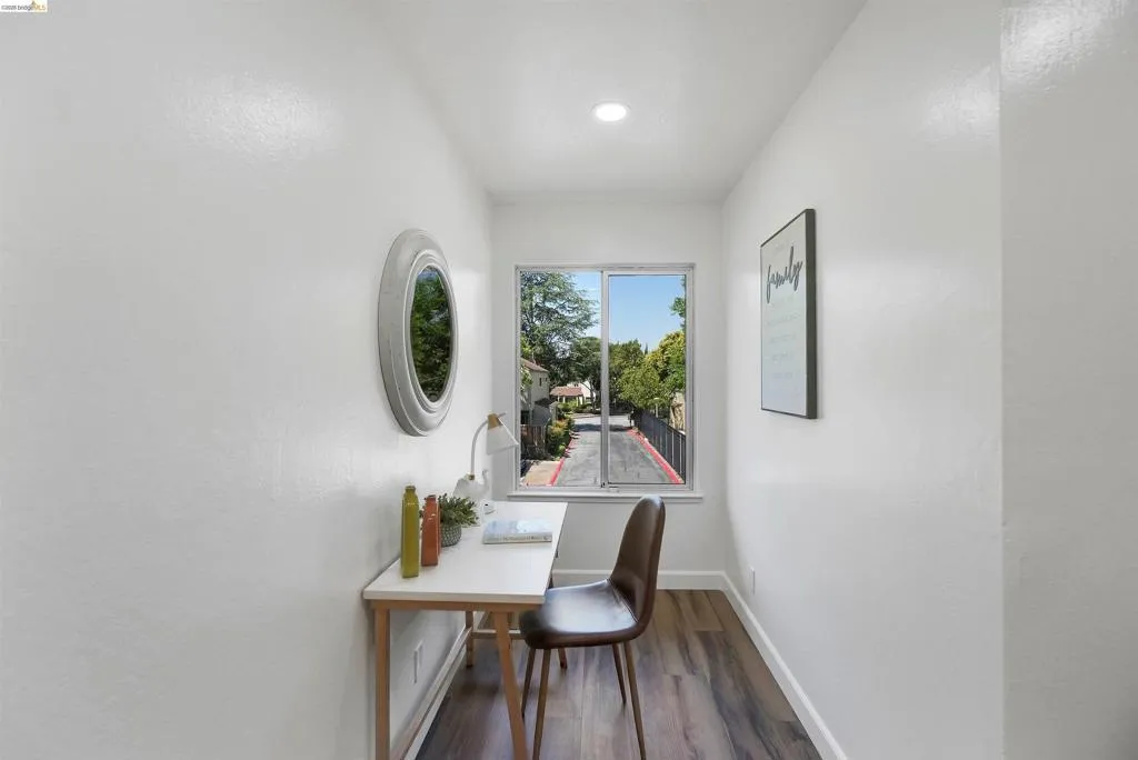 Compact room featuring a single window, recessed lighting, and wood-finish flooring