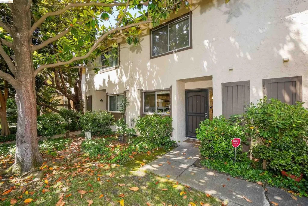 Stucco exterior with multi-pane windows and dark trim