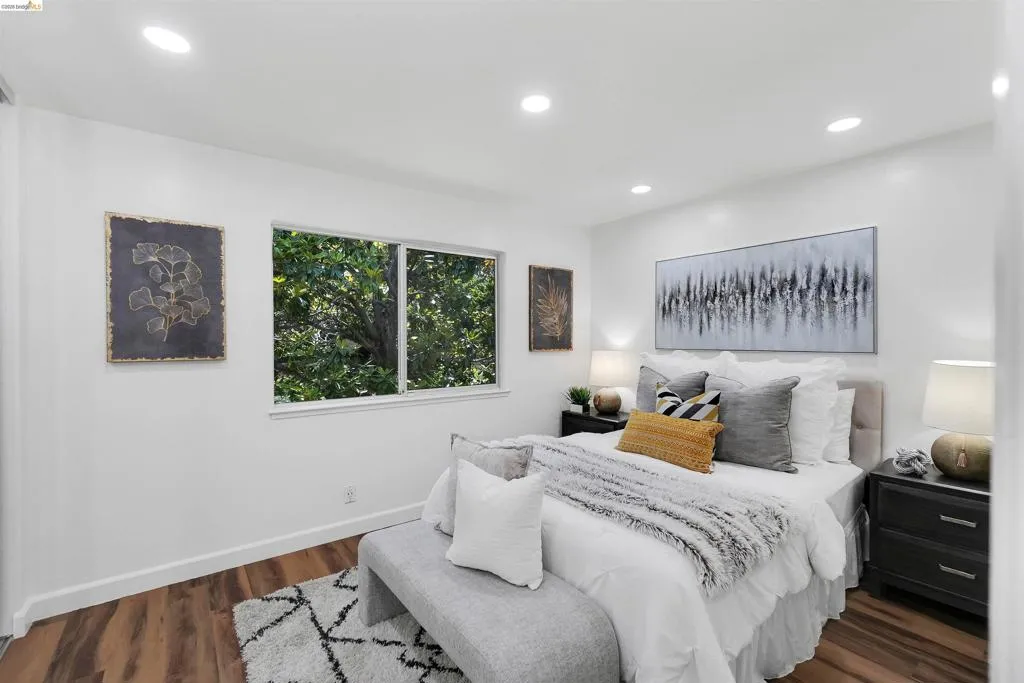 Bedroom featuring wood-finish flooring, recessed lighting, and a white color palette