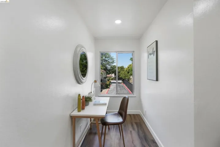 Compact room featuring a single window, recessed lighting, and wood-finish flooring
