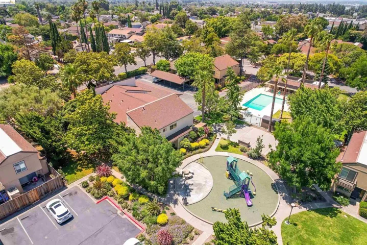 Aerial perspective showcasing a residential community with abundant mature trees and landscaping