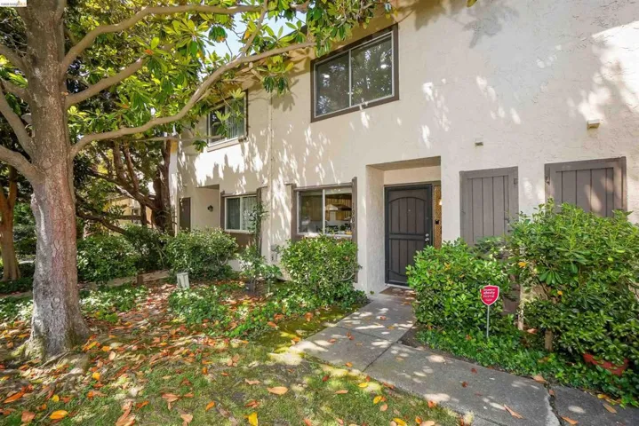 Stucco exterior with multi-pane windows and dark trim
