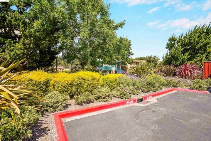 Landscaped grounds featuring mature trees and varied shrubbery