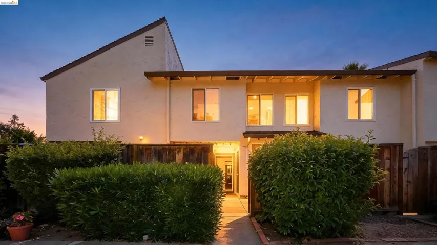 Contemporary exterior with stucco facade and a gabled roofline