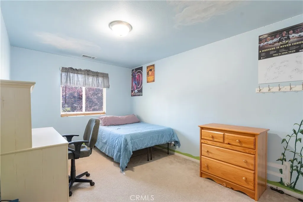 Guest bedroom with adorable decor on the walls and ceiling.
