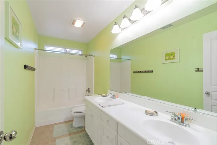 Guest bathroom with dual sinks.
