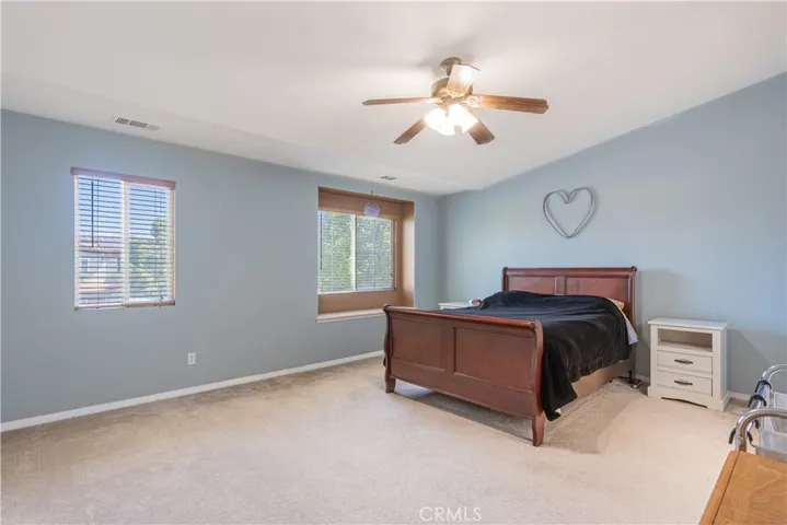 Spacious primary bedroom with delightful overhead fan.