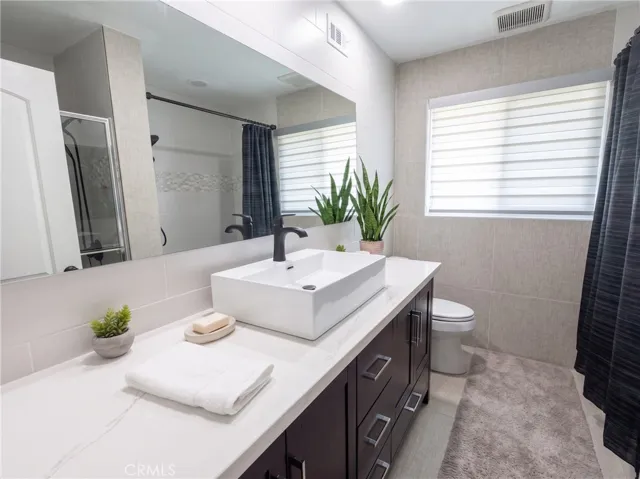 Hall bathroom with separate bathtub and shower