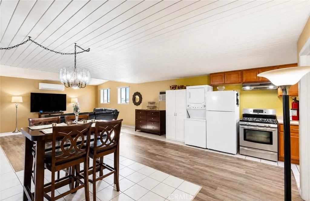 Another view of Unit #2, showcasing the dining area, kitchen, living room, and convenient in-unit laundry.