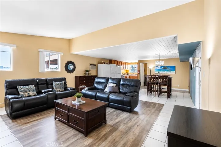 Unit #2 features an inviting living room, dining area, and kitchen, offering a comfortable and functional space for independent living.