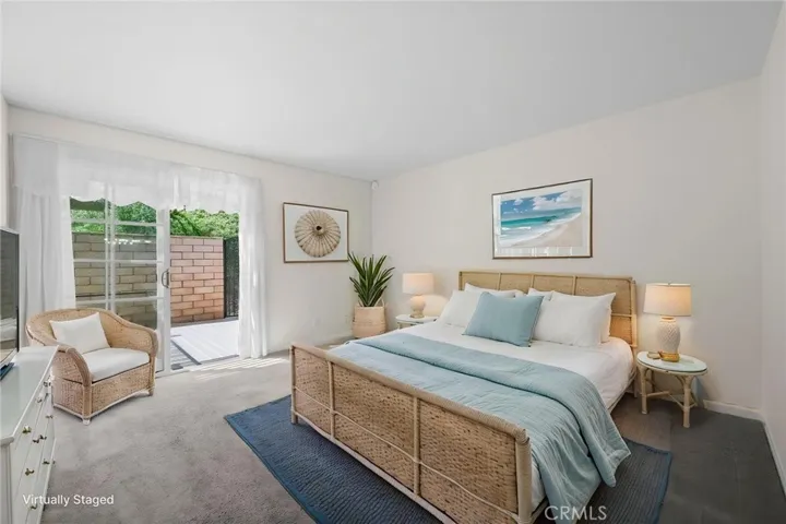 Primary Bedroom has sliding door access to the rear patio area.