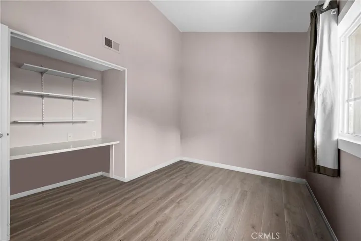 Secondary Bedroom #2 has a closet area (currently set up as a work station with desktop and shelving).
