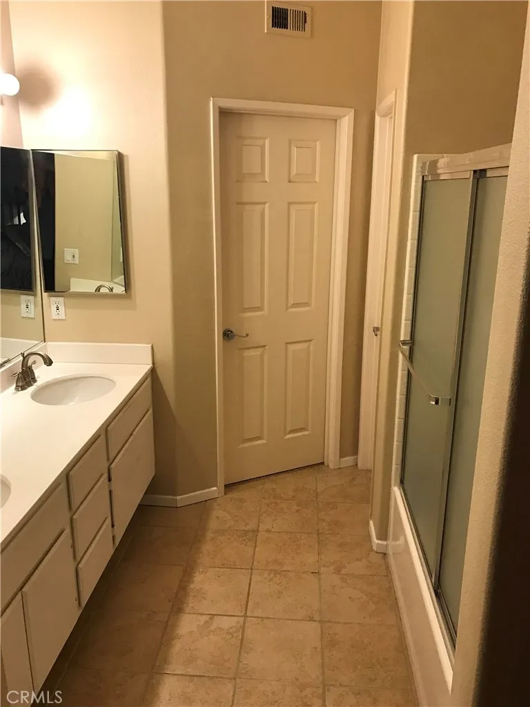 Another view of Primary Bathroom. Walk In Closet straight ahead.