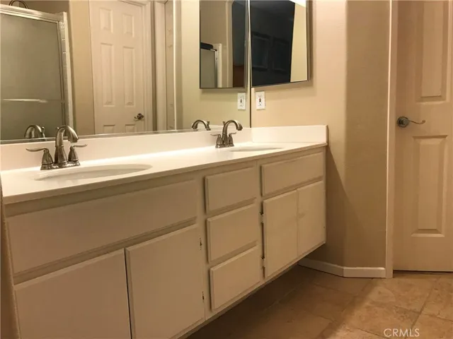 Primary Bathroom Double Sink Vanity, Tub with Shower overhead.