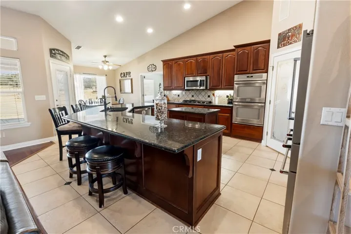 Kitchen with large double islands and walk-in pantry.
