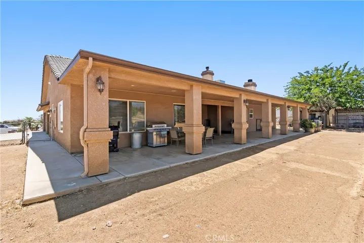 Large rear covered patio with lighting.