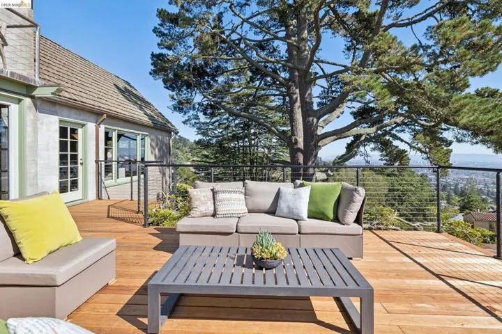 Expansive wood deck with cable railing and tree canopy