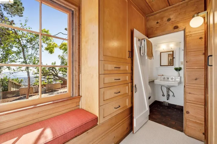 Built-in cabinetry and drawers complement the wood-paneled walls and ceiling