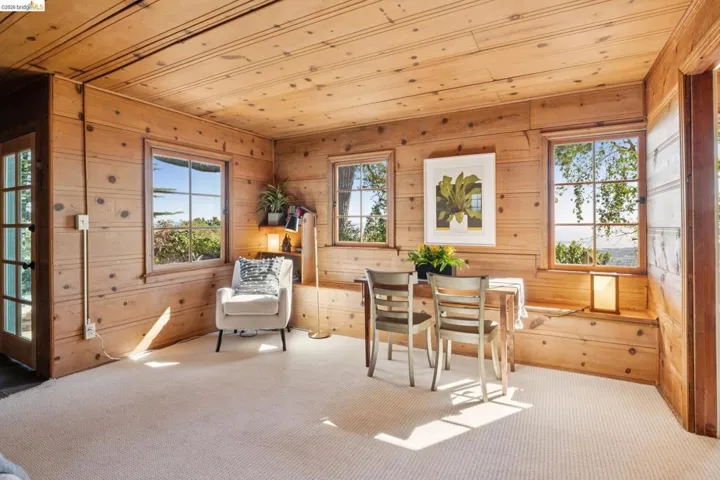 Interior room with extensive wood paneling on walls and ceiling