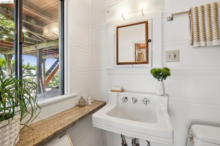 Pedestal sink with wall-mounted faucets and integrated soap dish