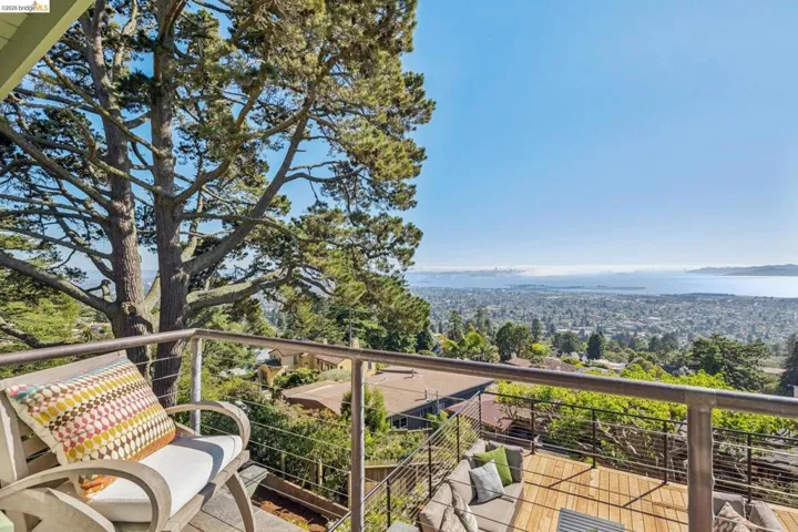 Expansive outdoor deck featuring wood-finish flooring and a cable railing system