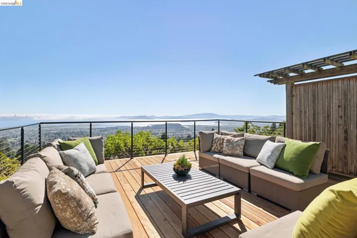 Expansive outdoor deck featuring wood flooring and a cable railing system