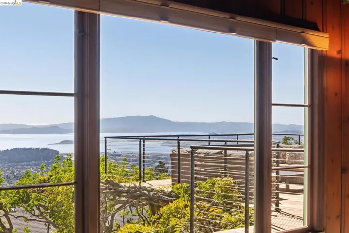 Expansive window framing unobstructed view of SF Bay, SF Skyline 3 bridges and 7 counties