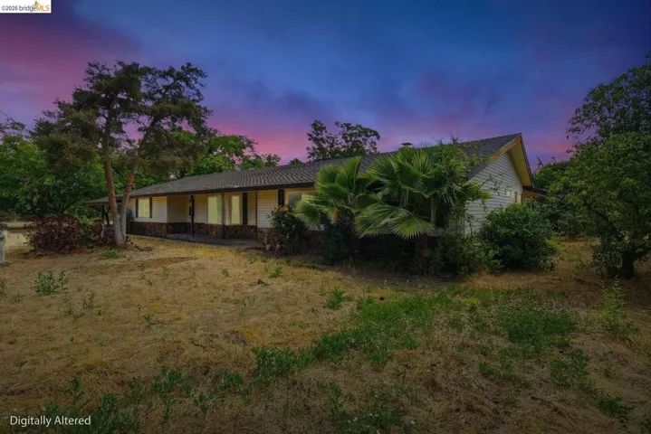 Back of house and fields with twilight