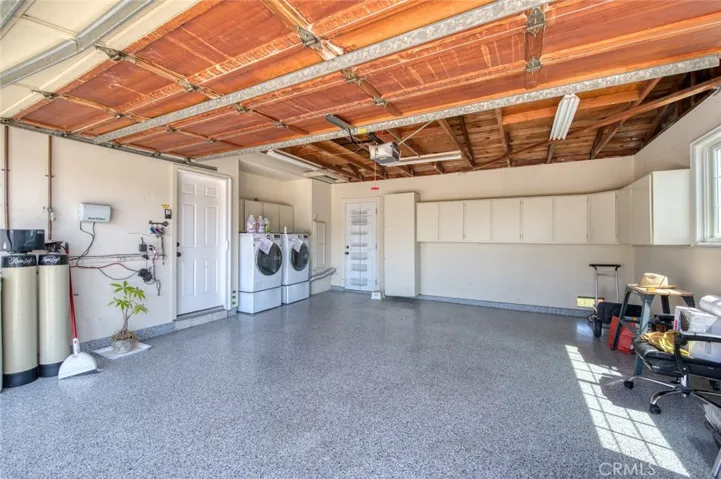 Direct access 2-car epoxy floor garage with washer, dryer and additional storage.