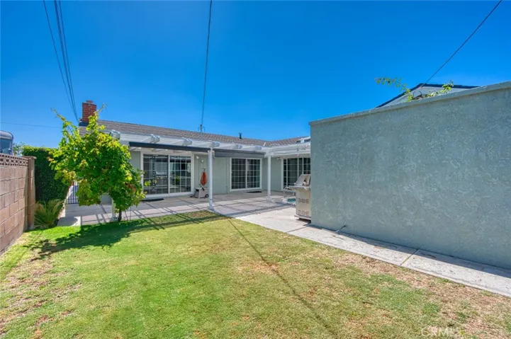 Private back yard with grassy lawn.
