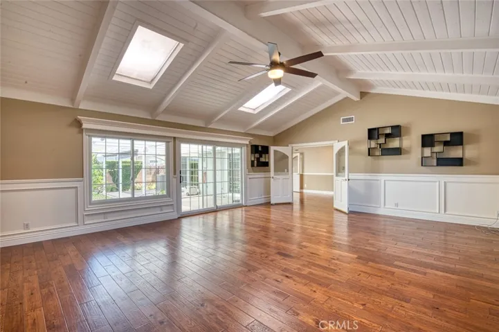 Massive primary bedroom suite with vaulted beam ceilings, ceiling fan, skylights and easy back yard access.