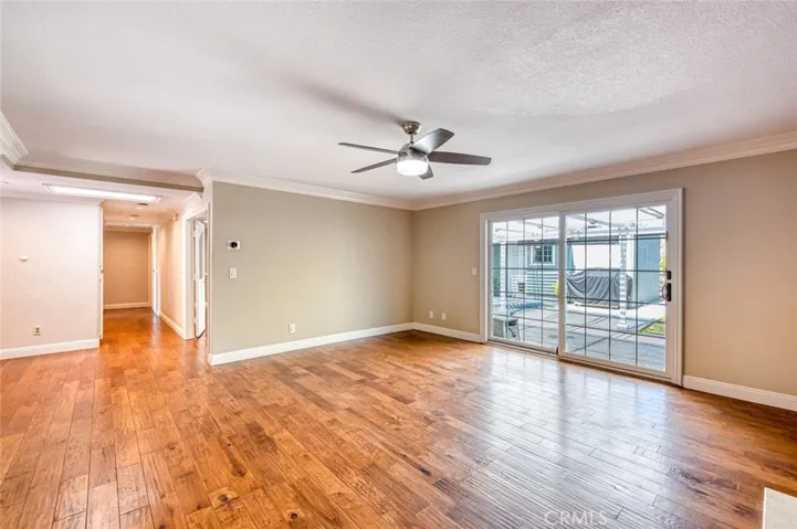 Living room with ceiling fan and easy back yard access.