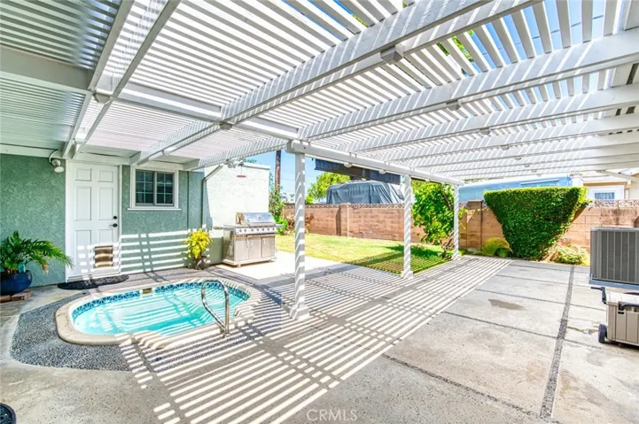 Private back yard with relaxing spa, BBQ and grassy lawn.