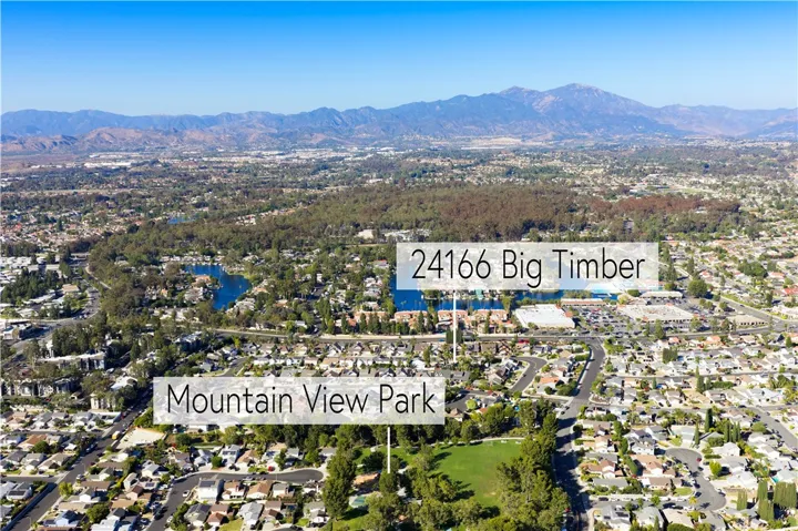 Drone perspective of neighborhood, house location, and Saddleback Mountain in the background.