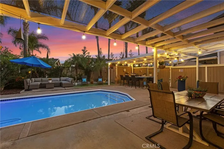 View looking out at the pool, spa, and BBQ island.