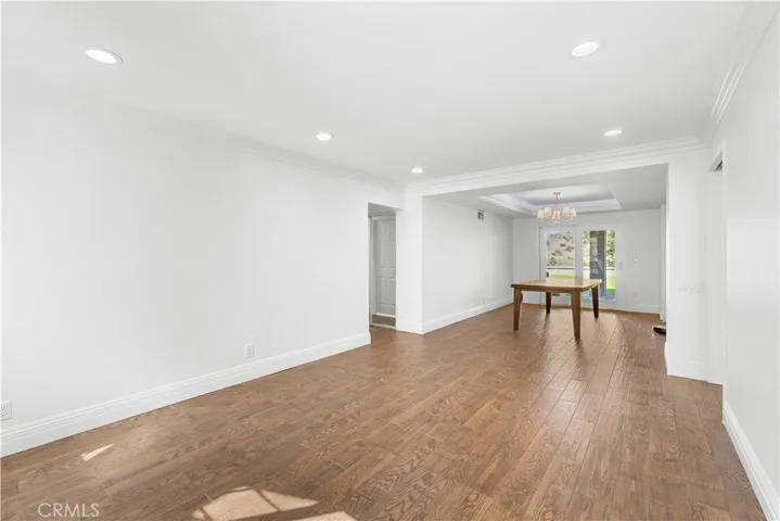 View from foyer into living room with dining room in the distance.