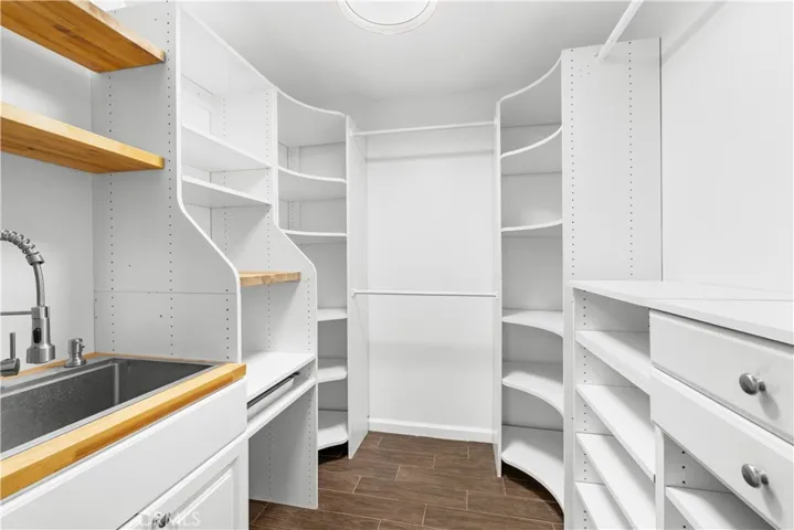 Primary bedroom walk-in closet with kitchenette.