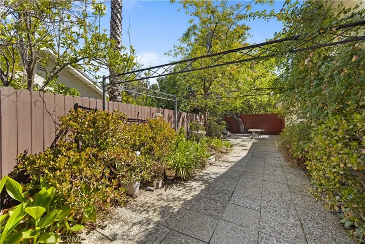 Unusually large side yard with lush landscaping, trellis, 6' diameter tradition fountain, and plenty of additional patio space.