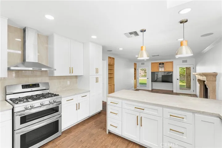 Kitchen with stainless steel appliances is open to the family room for excellent social interaction.